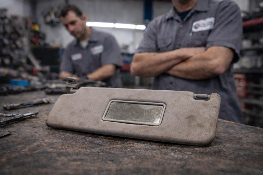 Technician inspecting used sun visor