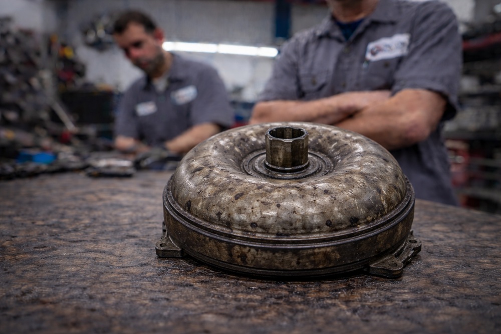 Technician inspecting used torque converter